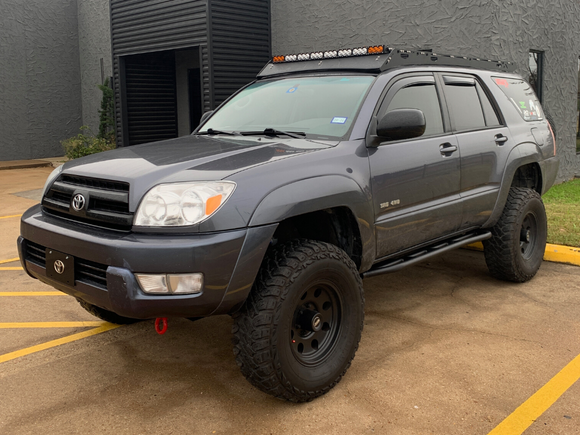 Front drivers side view of gray 4Runner with Trail Edition bolt on rock sliders - Cali Raised LED