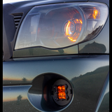 amber led fog light kit mounted on a toyota tacoma